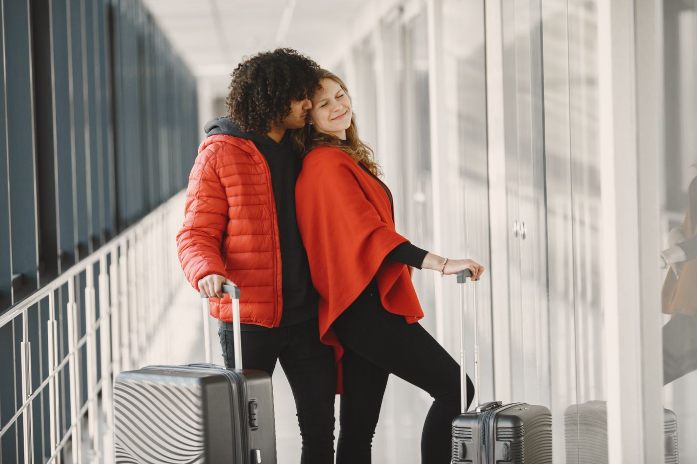 Happy travellers with their suitcases at the airport