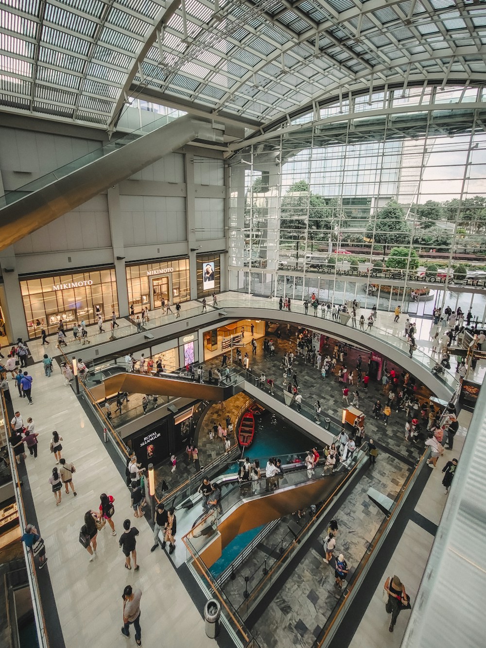 Bright shopping arcade with glass roof and stores
