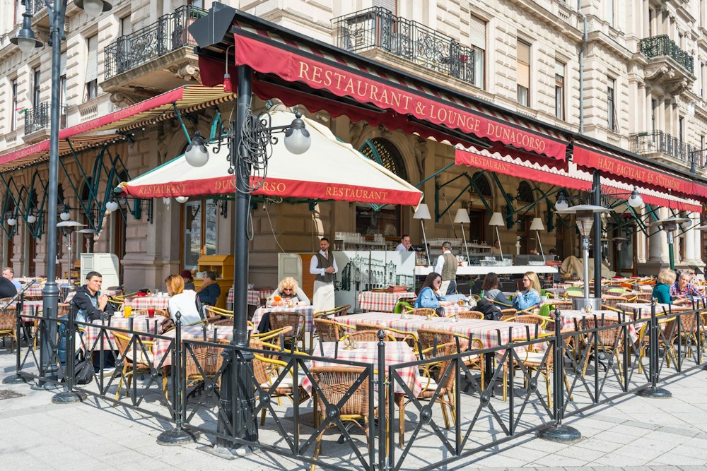 Lively outdoor restaurant terrace with guests dining